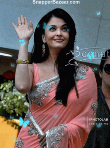 A Woman In A Pink Saree Is Being Photographed By Snapper Bazaar GIF