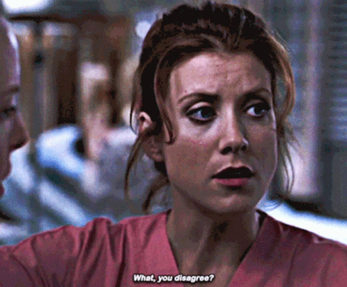 Woman In Pink Scrubs Talking To Man GIF