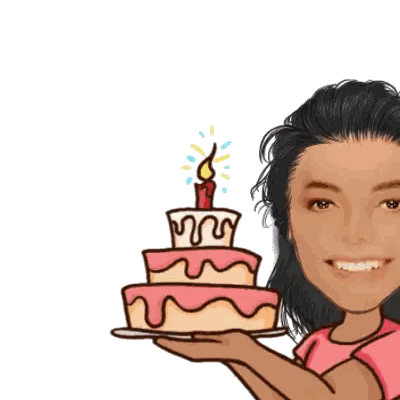 a woman in a pink shirt is holding a birthday cake with a lit candle