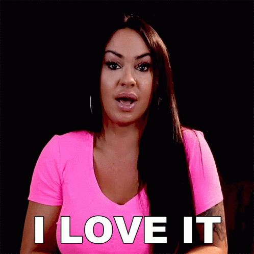 A Woman In A Pink Shirt Is Saying " I Love It " GIF