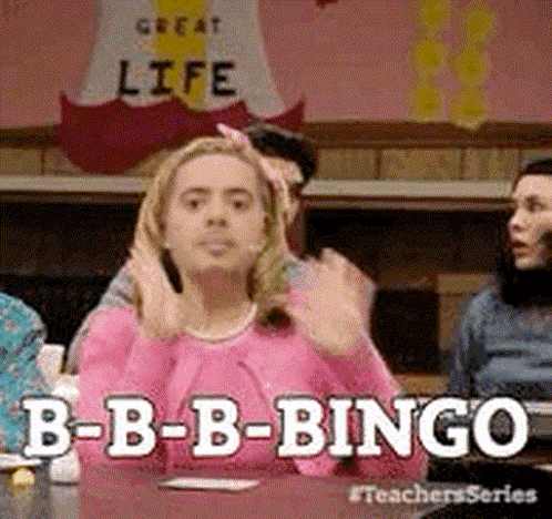 a woman in a pink shirt is sitting at a table playing bingo with other people .