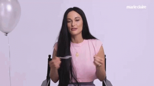 A Woman In A Pink Shirt Is Sitting In A Chair And Says `` I Know Because '' . GIF