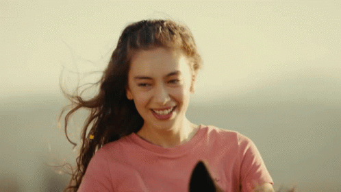 A Woman In A Pink Shirt Is Smiling And Holding A Horse GIF
