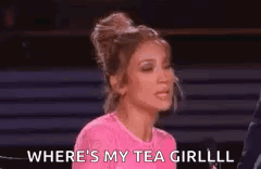 A Woman In A Pink Shirt Is Talking Into A Microphone And Saying `` Where 'S My Tea Girl ? '' GIF
