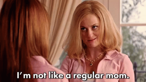 A Woman In A Pink Shirt Is Talking To Another Woman In Front Of A Window . GIF