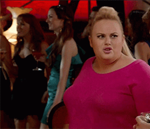 A Woman In A Pink Shirt Stands In A Crowd Of Women GIF