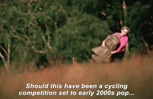 Woman In Pink Sweater Holding Large Rock GIF