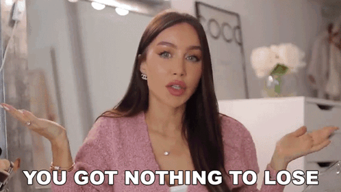 A Woman In A Pink Sweater Is Making A Funny Face And Saying You Got Nothing To Lose . GIF