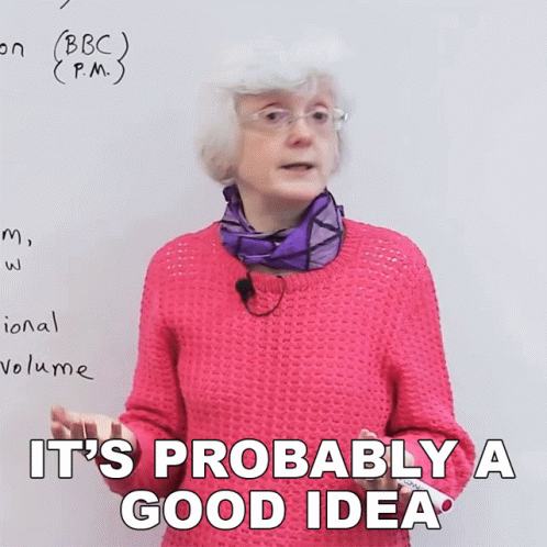 A Woman In A Pink Sweater Says It 'S Probably A Good Idea In Front Of A White Board GIF