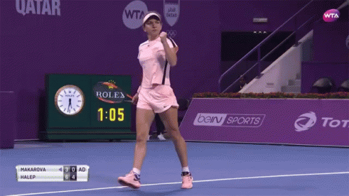 A Woman In A Pink Tennis Outfit Is Celebrating A Win GIF