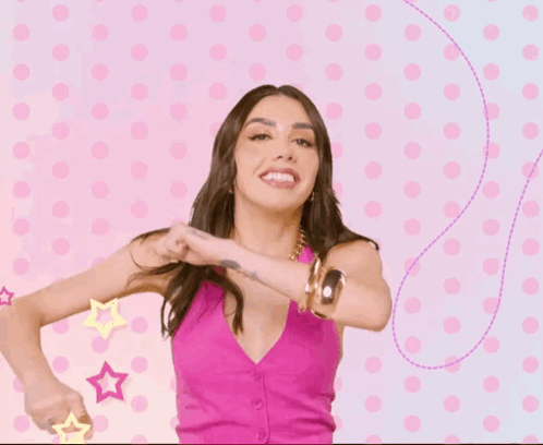 A Woman In A Pink Top And Gold Bracelets Is Dancing GIF