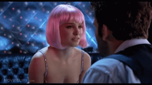 A Woman In A Pink Wig Is Kissing A Man In A Movie . GIF