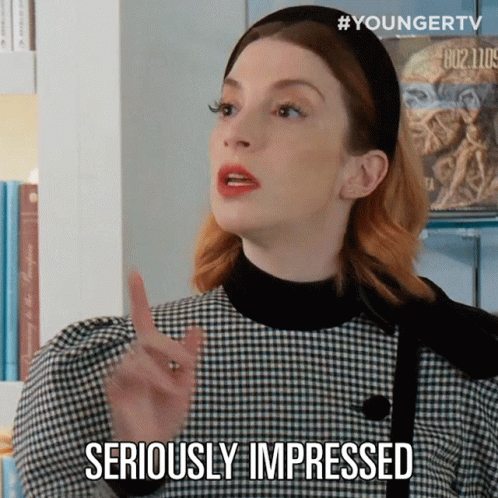 A Woman In A Plaid Dress Is Making A Gesture And Says Seriously Impressed GIF