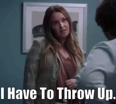 A Woman In A Plaid Jacket Is Standing Next To A Man And Says I Have To Throw Up GIF