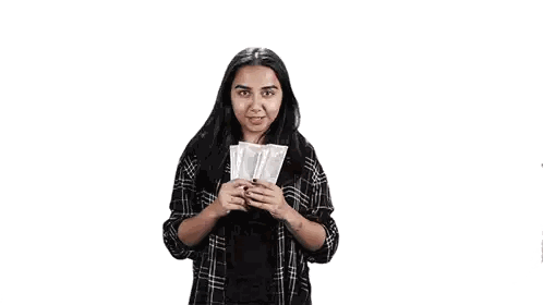 a woman in a plaid shirt is dancing in front of a white background