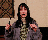 a woman in a plaid shirt is holding a knife