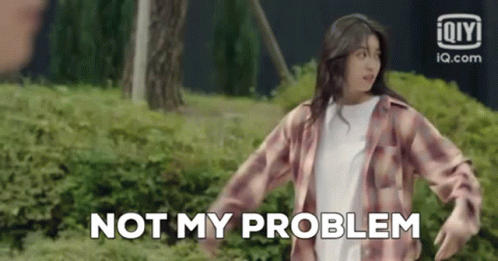 A Woman In A Plaid Shirt Is Standing In Front Of A Bush . GIF