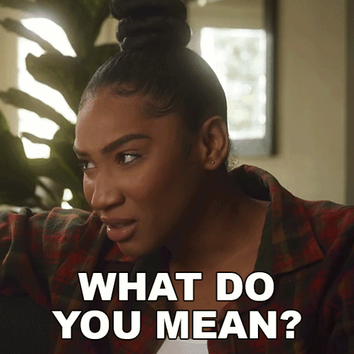 A Woman In A Plaid Shirt Says " What Do You Mean " GIF