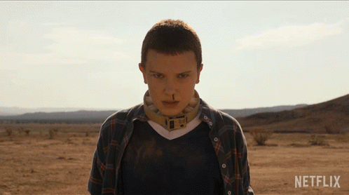 A Woman In A Plaid Shirt Stands In The Desert With Netflix Written On The Bottom GIF