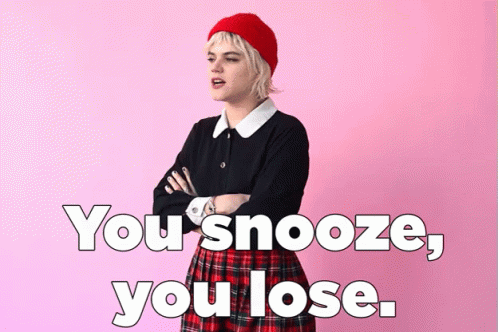 A Woman In A Plaid Skirt Is Standing With Her Arms Crossed In Front Of A Pink Background With The Words You Snooze You L GIF