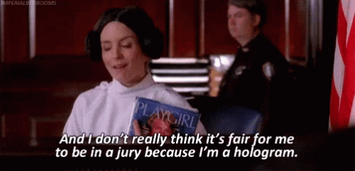 A Woman In A Playgirl Costume Is Sitting In A Courtroom Holding A Playgirl Magazine . GIF