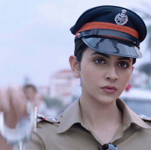 A Woman In A Police Uniform With A Badge That Says ' Delhi ' On It GIF