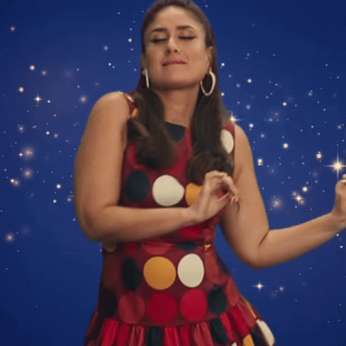 A Woman In A Polka Dot Dress Is Dancing GIF