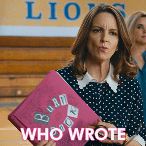 A Woman In A Polka Dot Shirt Is Holding A Pink Folder That Says Burn Book GIF