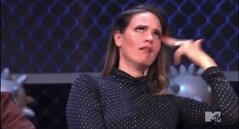 A Woman In A Polka Dot Shirt Is Making A Funny Face With The Letter M In The Corner GIF