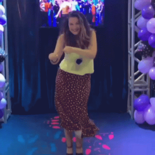 Woman In Polka Dot Skirt Dancing With Microphone GIF