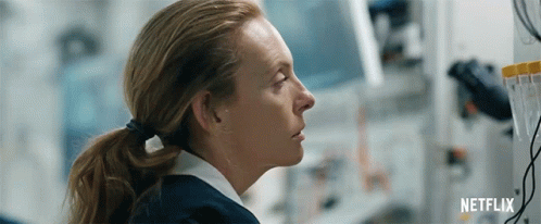 A Woman In A Ponytail Is Looking At A Computer Screen In A Lab . GIF