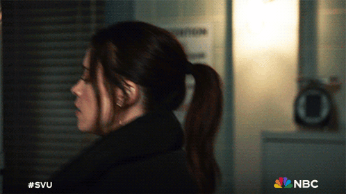A Woman In A Ponytail Is Standing In Front Of A Sign That Says Nbc GIF