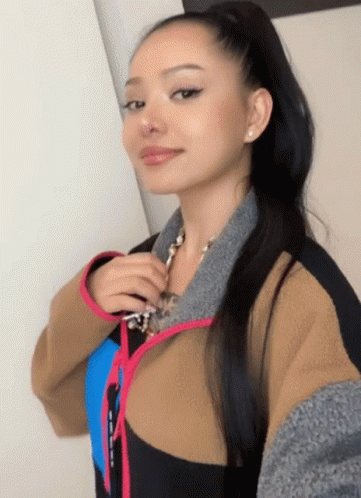 A Woman In A Ponytail Takes A Selfie With Her Phone GIF