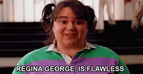 A Woman In A Purple And Green Striped Shirt Is Smiling And Says `` Regina George Is Flawless '' . GIF