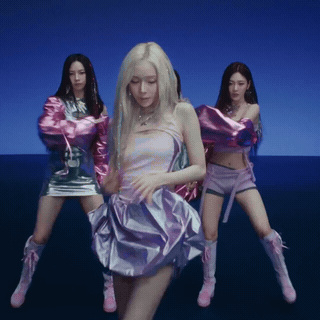 A Woman In A Purple Dress Is Dancing With Two Other Girls GIF