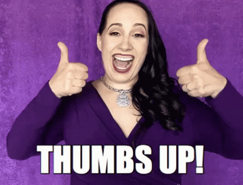 A Woman In A Purple Dress Is Giving Two Thumbs Up And The Caption Says Thumbs Up ! GIF
