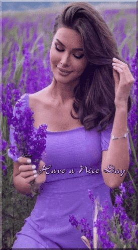 A Woman In A Purple Dress Is In A Field Of Purple Flowers With The Words Have A Nice Day Below Her GIF