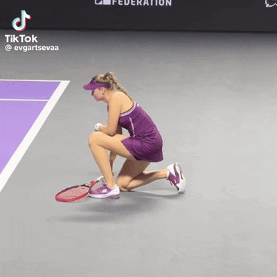 a woman in a purple dress is kneeling down on a tennis court with a tiktok watermark