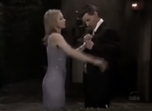 a woman in a purple dress is shaking hands with a man in a suit and bow tie