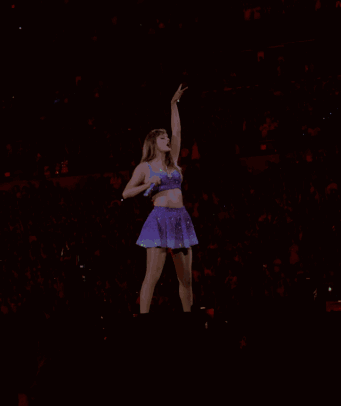 Woman In Purple Dress Singing Into Microphone GIF