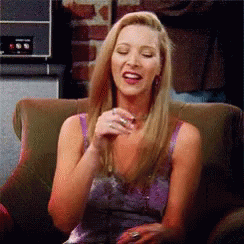 A Woman In A Purple Dress Is Sitting In A Chair With Her Eyes Closed And Smiling . GIF