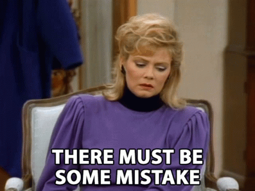 A Woman In A Purple Dress Is Sitting In A Chair With The Words There Must Be Some Mistake Below Her GIF