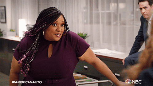 Woman In Purple Dress In Front Of Americanauto Sign GIF
