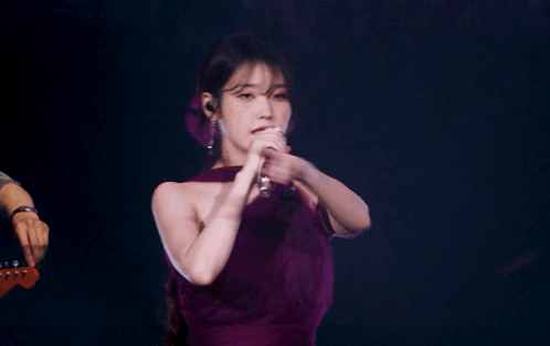 A Woman In A Purple Dress Singing Into A Microphone With The Words Slayed It In Blue GIF