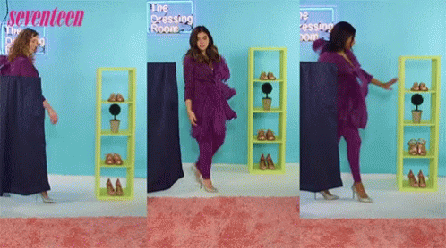 A Woman In A Purple Outfit Is Standing In Front Of A Sign That Says Seventeen GIF