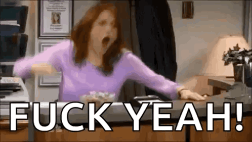 a woman in a purple shirt is yawning while sitting at a desk with the words `` fuck yeah '' .