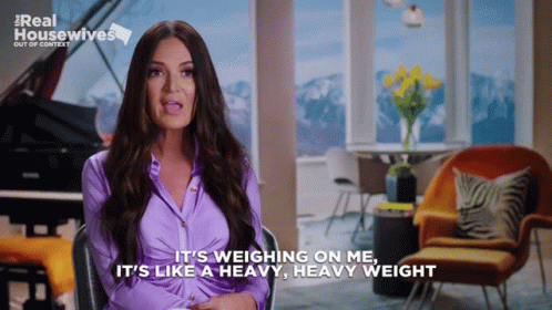 A Woman In A Purple Shirt Says It 'S Weighing On Me And It 'S Like A Heavy Heavy Weight GIF