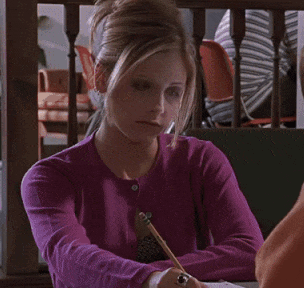 A Woman In A Purple Sweater Is Sitting At A Table And Says " You 'Re Not Stupid " GIF