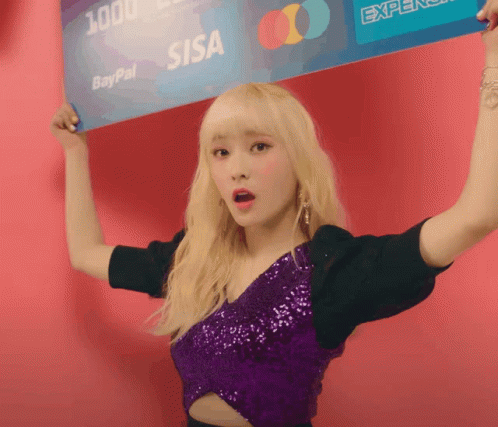 A Woman In A Purple Top Holds Up A Paypal Card Over Her Head GIF