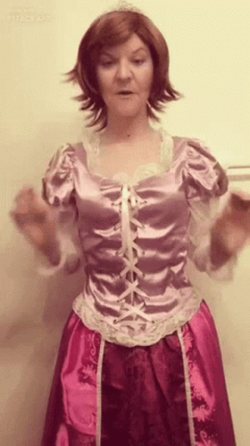 A Woman In A Rapunzel Costume Has Her Hands Outstretched GIF